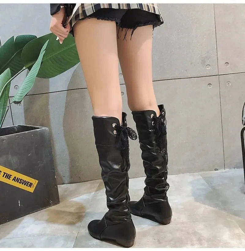 Women's pleated lace-up knee-high boots by TrendLux Wear, showcasing stylish design and textured fabric details.