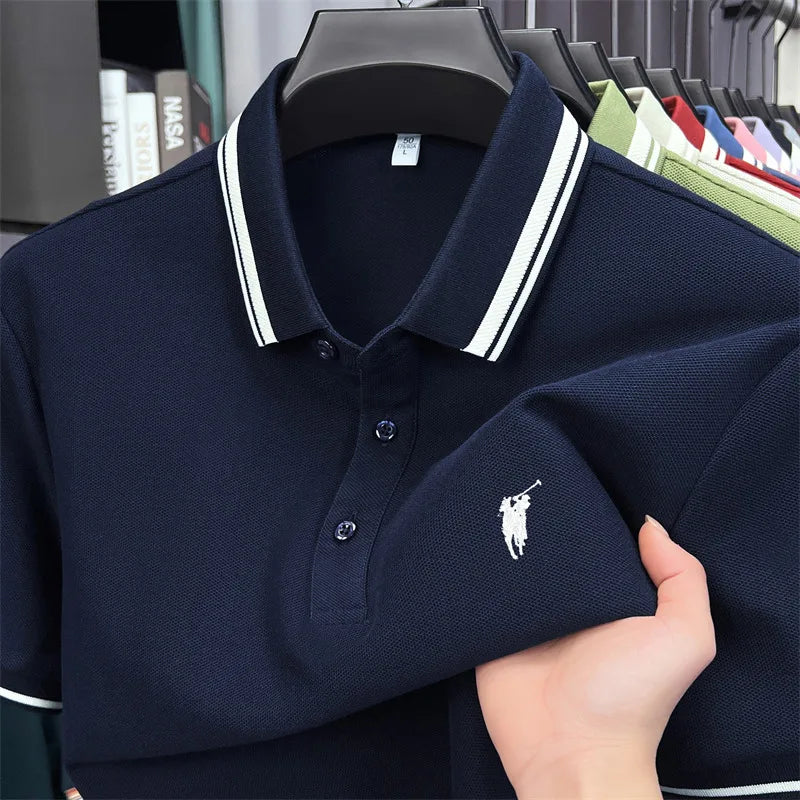 Navy blue short sleeve polo shirt with white-striped collar and pony logo embroidery, made of 100% cotton.