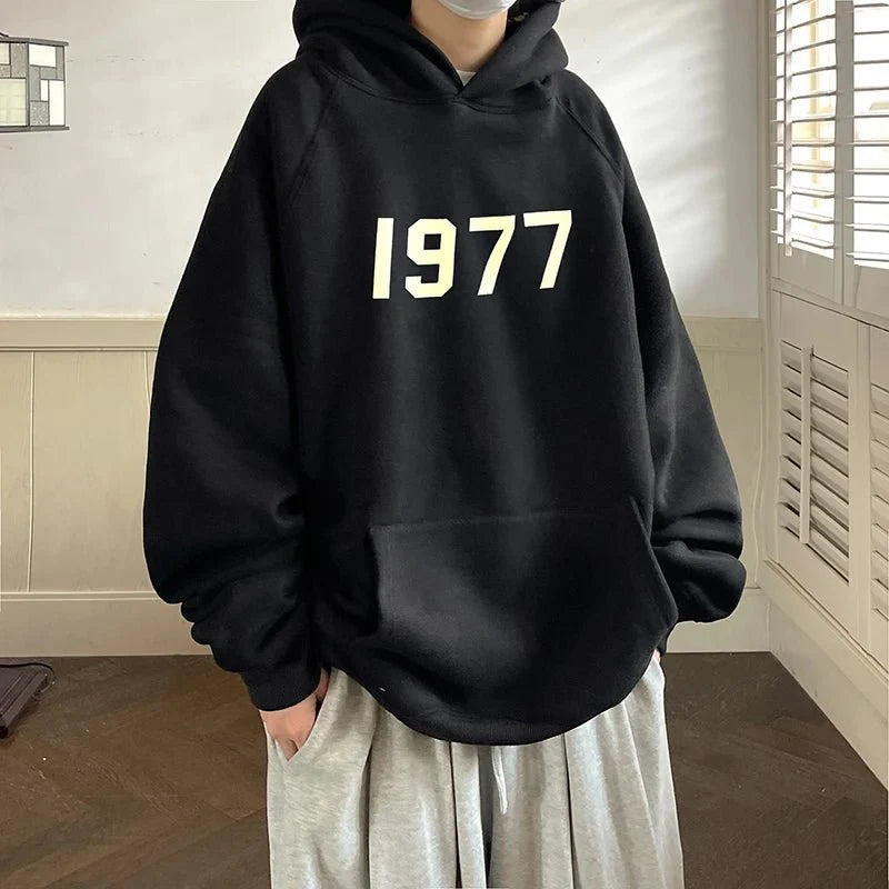 Men's TrendLux Wear 1977 printed Harajuku hoodie with loose fit long sleeves, casual sweatshirt in various sizes.