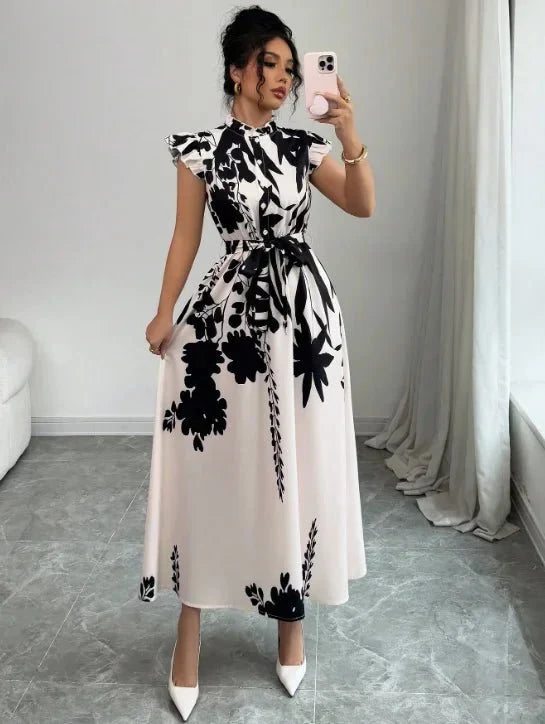 Women's black and white patchwork sash ball gown dress featuring a fitted bodice and flowing skirt by The Glow Sanctuary.