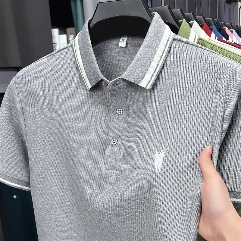 Gray short sleeve polo shirt with a classic fit, featuring a white pony embroidery and striped collar details.