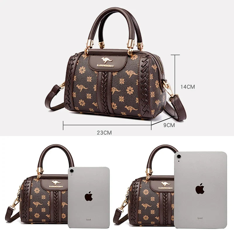Brown designer shoulder bag featuring woven detailing and floral patterns. Zipper closure with an adjustable strap.