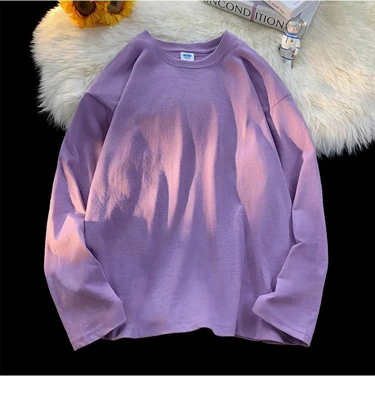 Unisex oversized long sleeve blank T-shirt by My Store 5 in neutral color, displayed flat with multiple color options in the background.