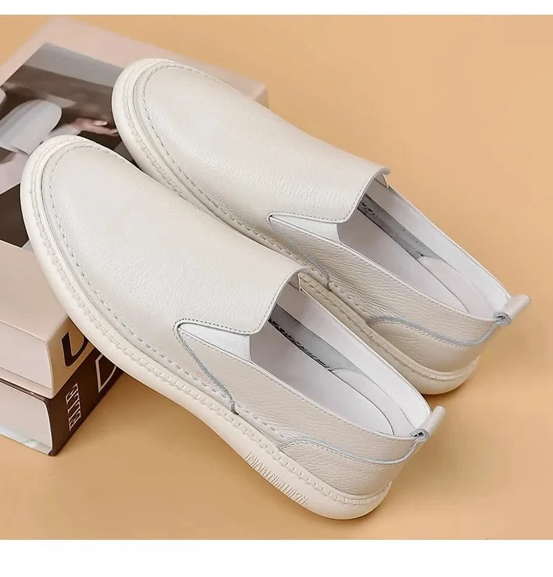 Men's genuine leather casual loafers by TrendLux Wear, breathable slip-on flat shoes in solid color with a sleek, comfortable design.