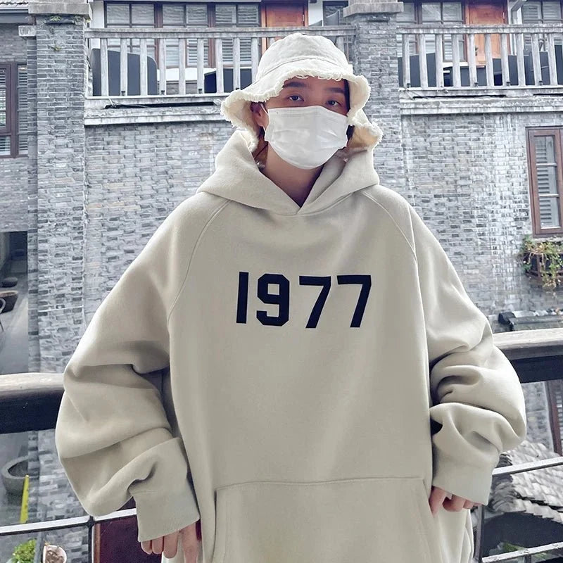 Men's TrendLux Wear printed Harajuku hoodie with loose fit, long sleeves, and 1977 design in black and white.