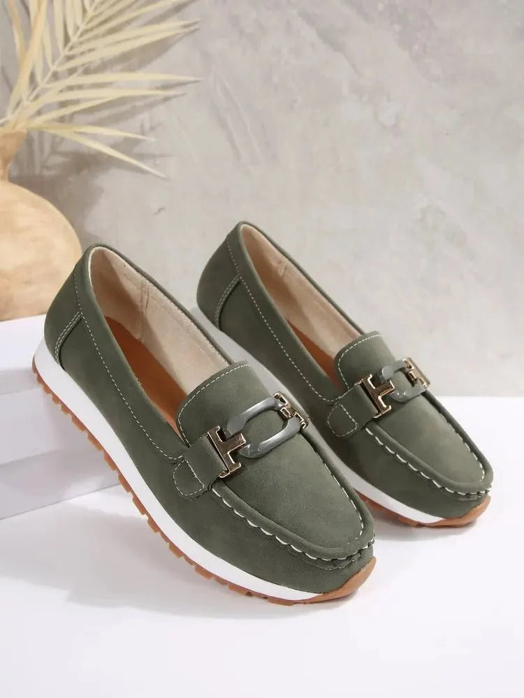 Women's slip-on flat shoes with buckle detail by TrendLux Wear, featuring a sleek design and comfortable fit.