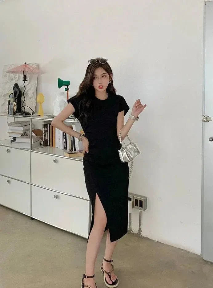 Black Y2K asymmetrical hem midi dress by The Glow Sanctuary, featuring a stylish streetwear-inspired design and modern silhouette.