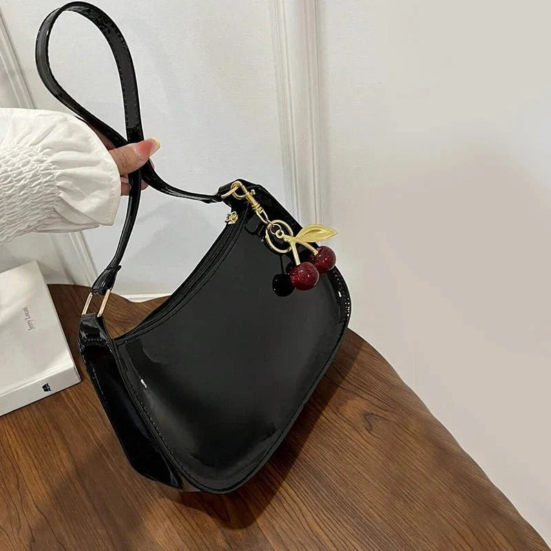 Women's pure leather cherry pendant handbag by TrendLux Wear, featuring a solid color design and a stylish cherry charm.