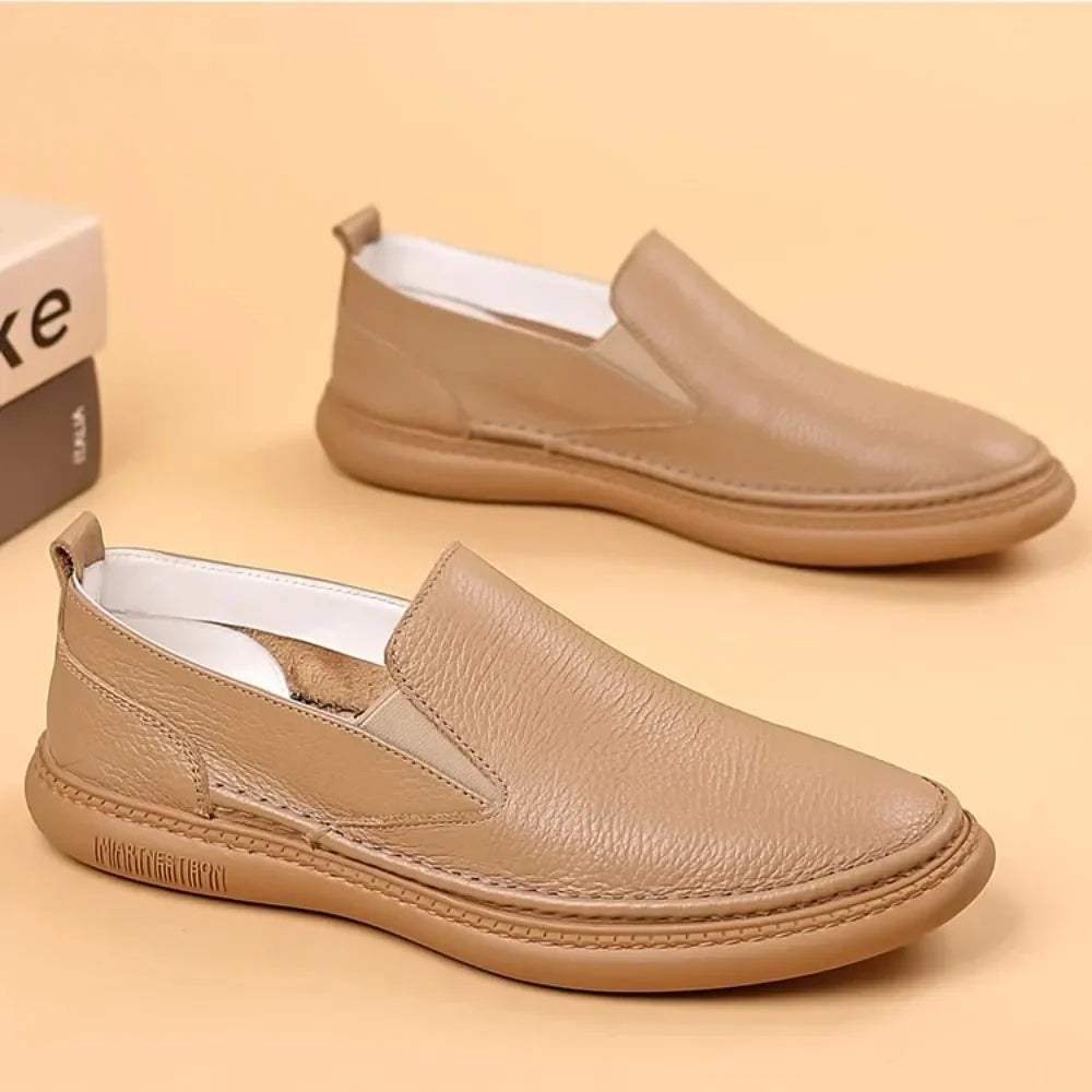 Men's genuine leather casual loafers by TrendLux Wear, breathable slip-on flat shoes in a solid color, suitable for everyday wear.
