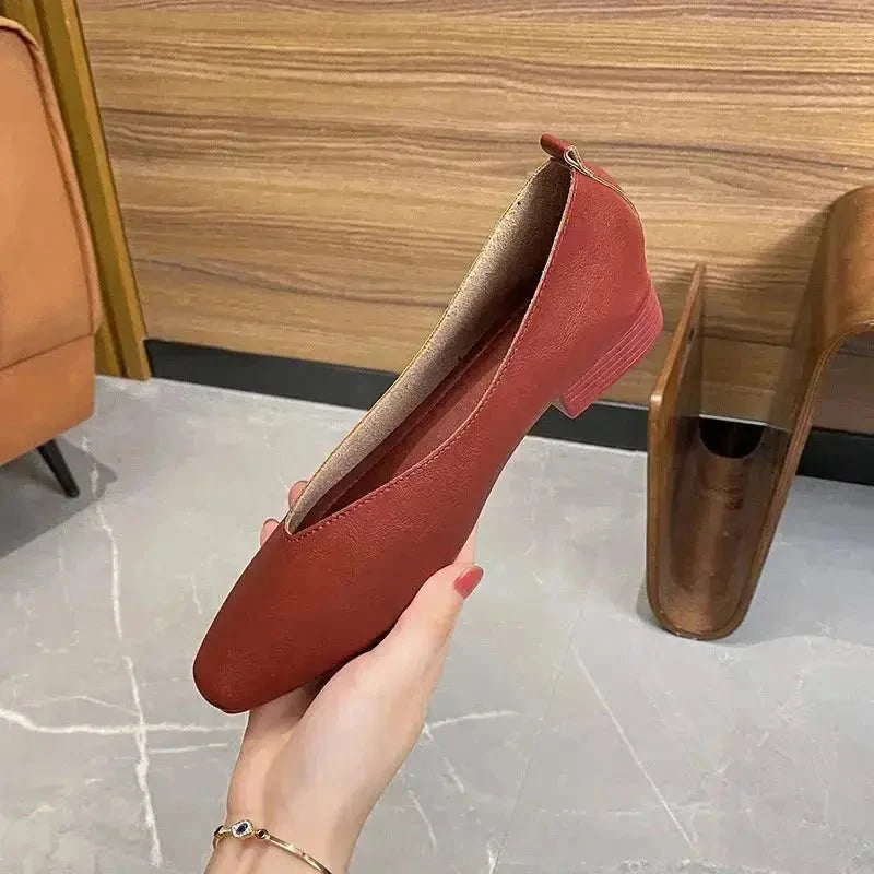 Women's round-toe leather loafer flats by TrendLux Wear, showcasing sleek black shoes with a polished finish and comfortable design.