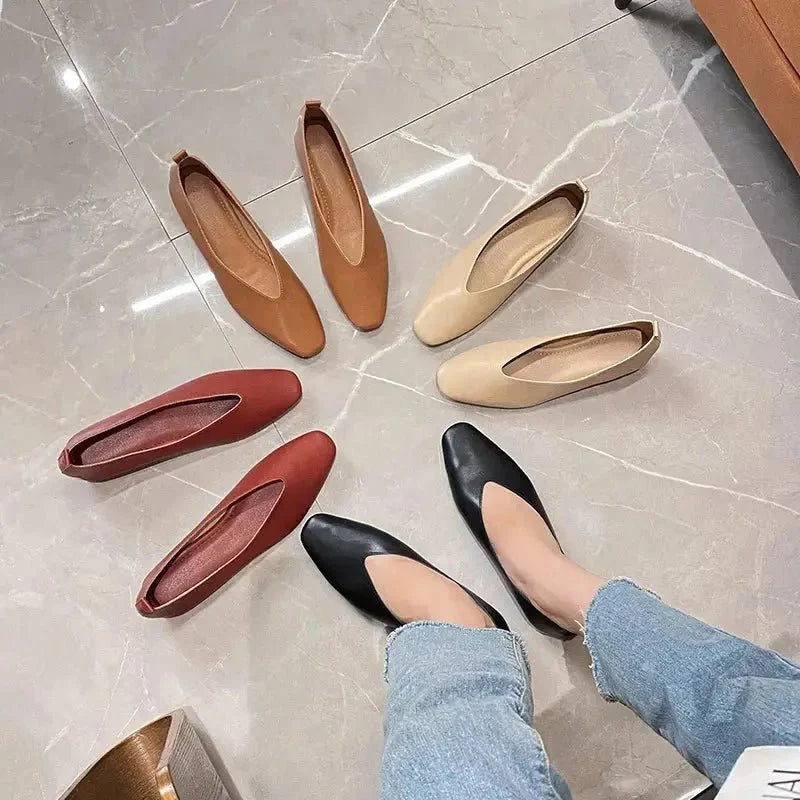 Women's round-toe leather loafer flats by TrendLux Wear, showing sleek black shoes with a smooth finish and comfortable slip-on design.