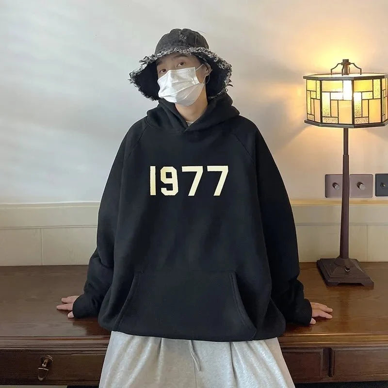 Men's TrendLux Wear 1977 Printed Harajuku hoodie with loose fit, long sleeves, and graphic design on soft sweatshirt fabric.