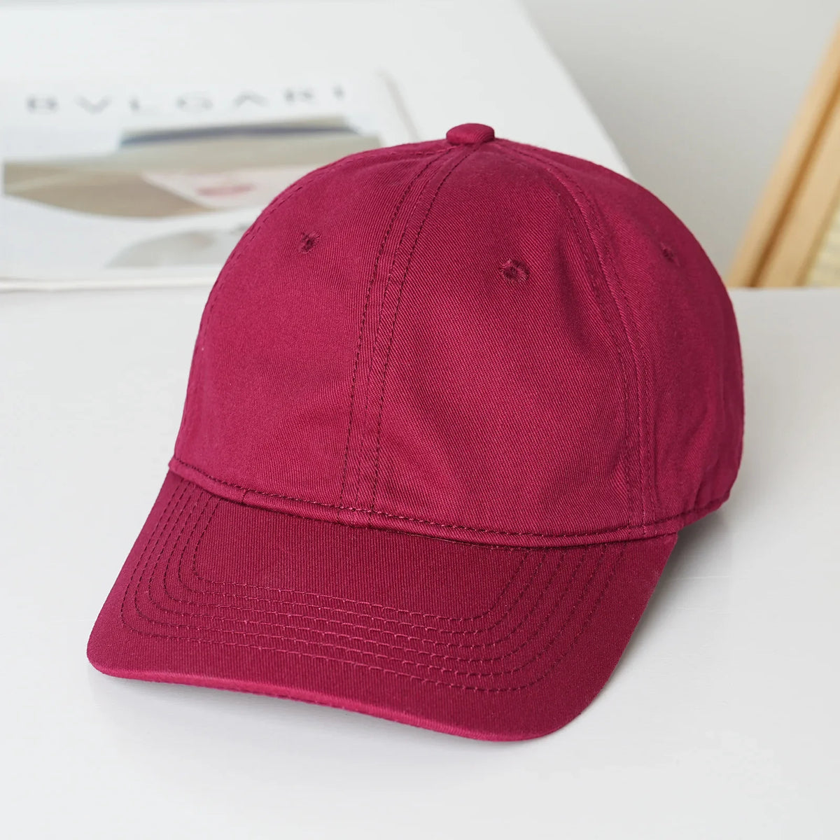 Unisex soft-top dad hat by TrendLux Wear, plain baseball cap with sun protection, available in 21 colors, shown in black.