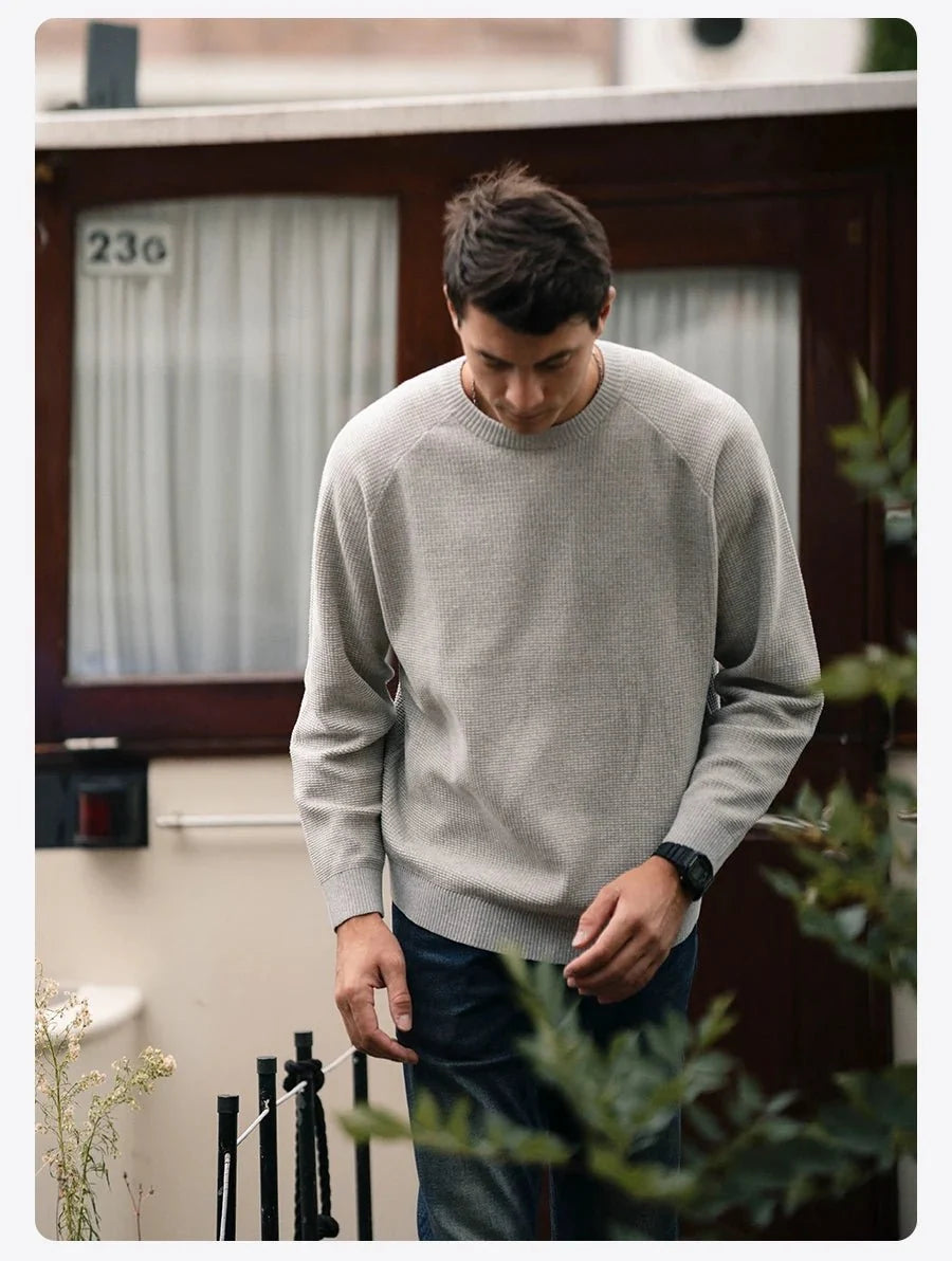 Men's oversized waffle-knit crewneck sweater in Heather Denim Blue by TrendLux Wear, casual pullover with textured knit fabric.