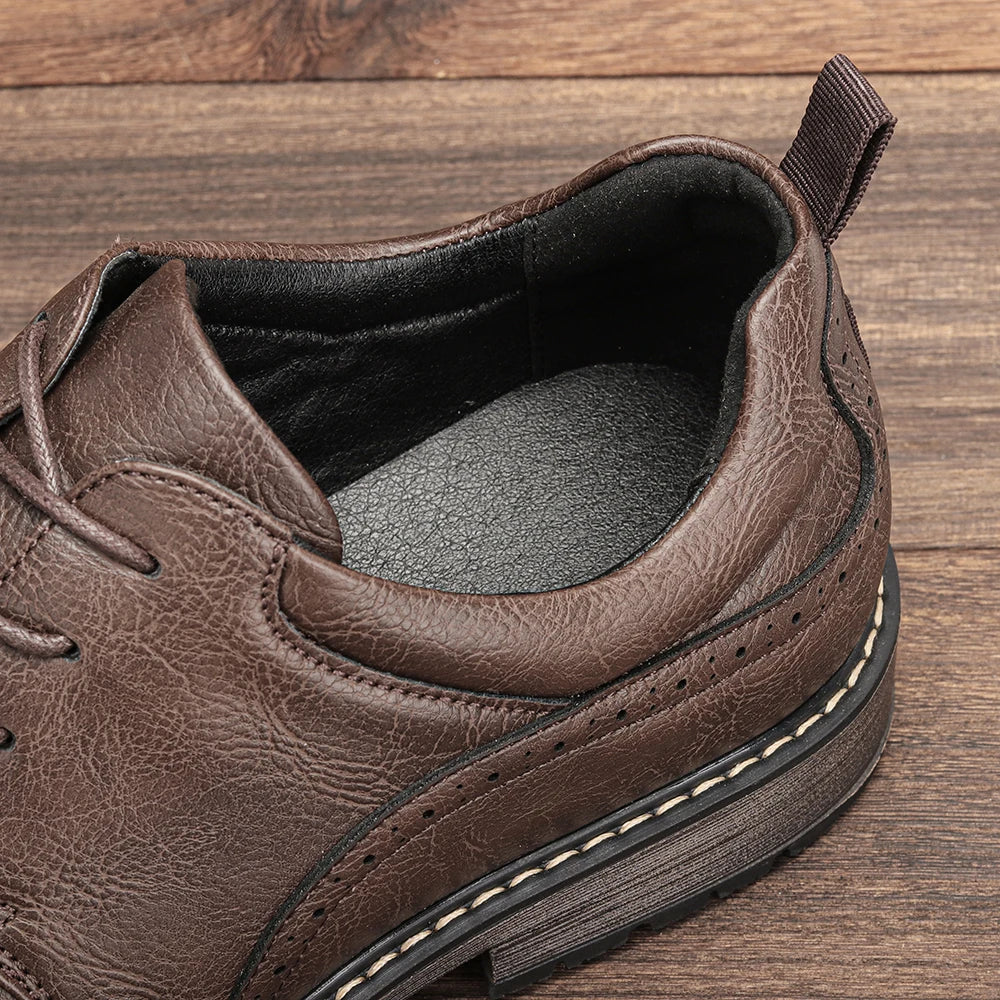 Brown leather men's dress shoes with round toe, lace-up closure, and rubber sole, featuring a textured finish.