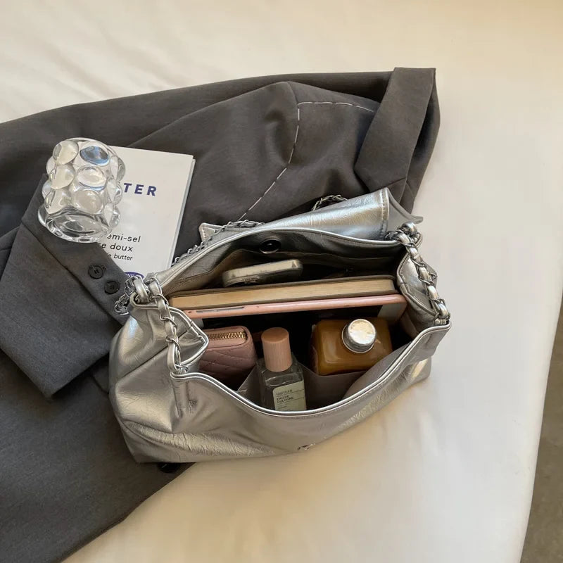Silver shoulder bag made of soft leather, featuring a large capacity and a stylish casual tote design.