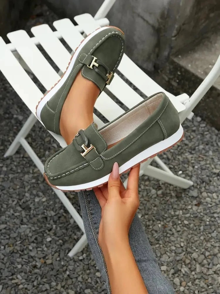 Women's slip-on shoes with buckle detail from TrendLux Wear, featuring a flat sole and stylish design.