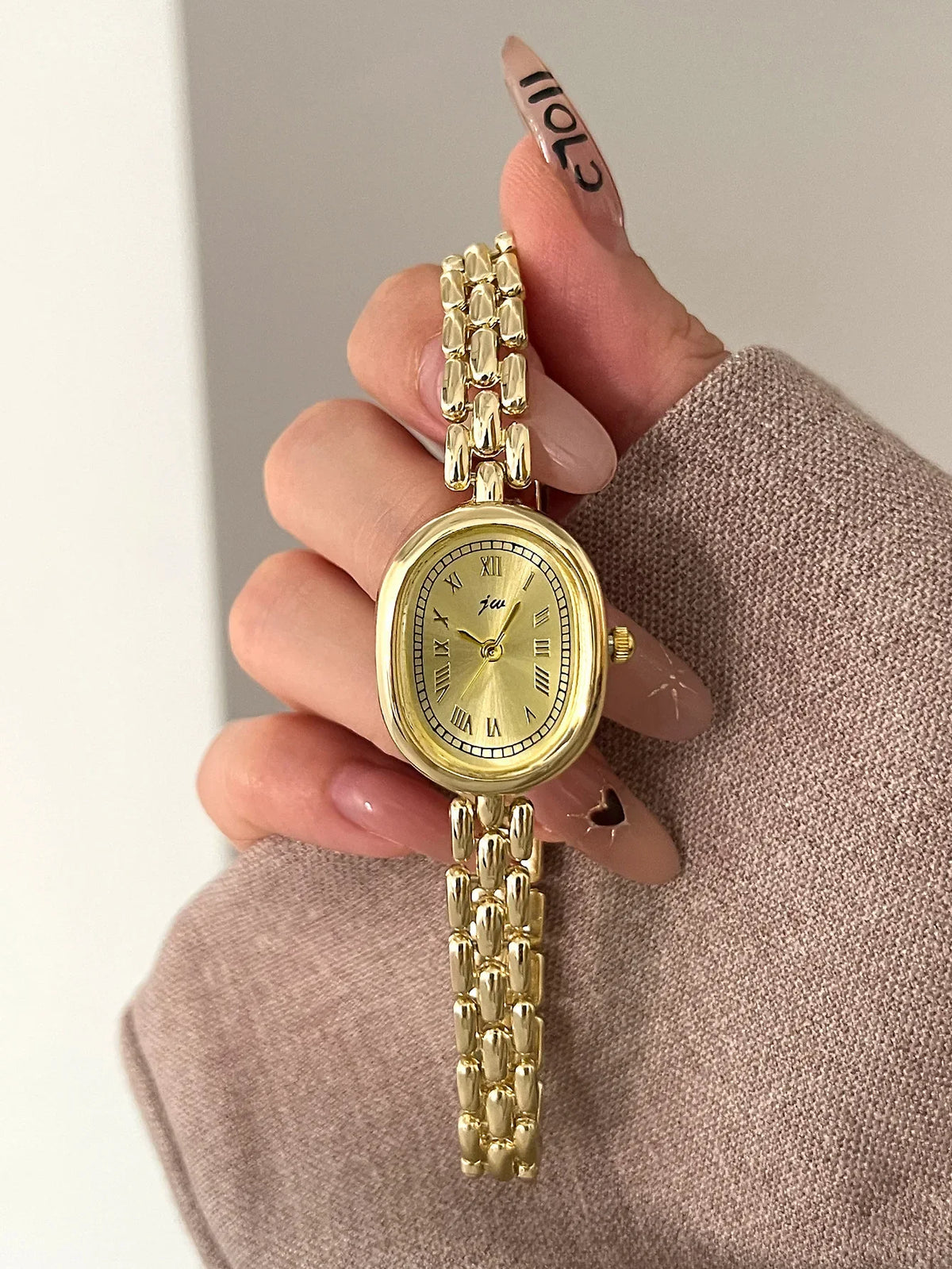 Women's TrendLux Wear oval artistic niche watch with a sleek design and elegant gold-tone finish.