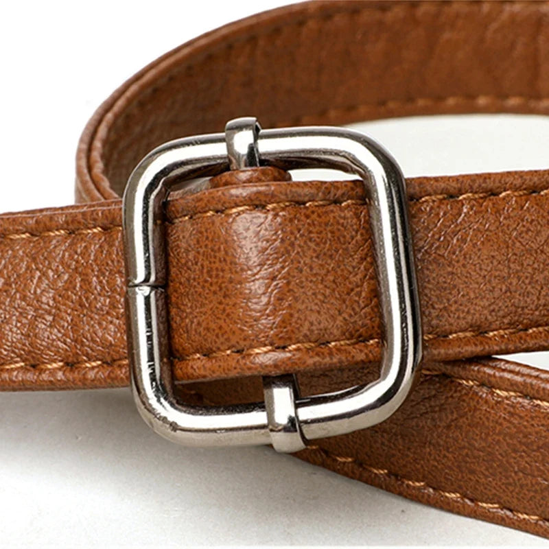 Brown leather strap with a rectangular silver buckle, showcasing detailed stitching and a textured finish.
