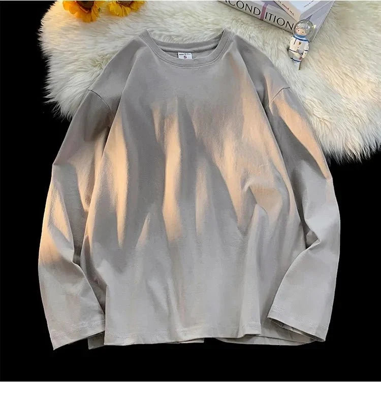 Unisex oversized long sleeve blank T-shirt in neutral color, casual streetwear style, shown in front view with relaxed fit.