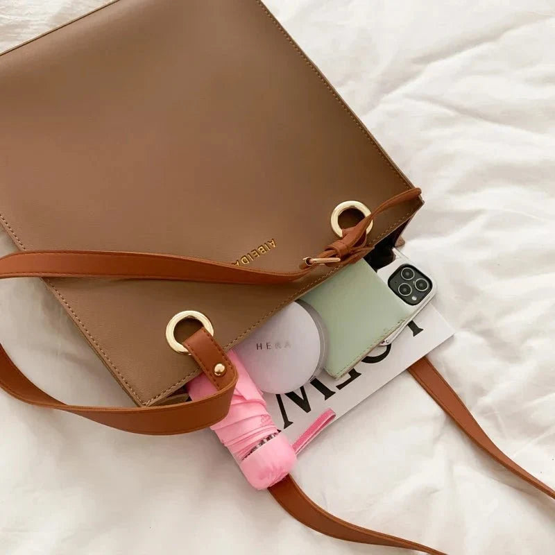 Large women's designer leather handbag by TrendLux Wear, showcasing sleek pure leather exterior and elegant design.