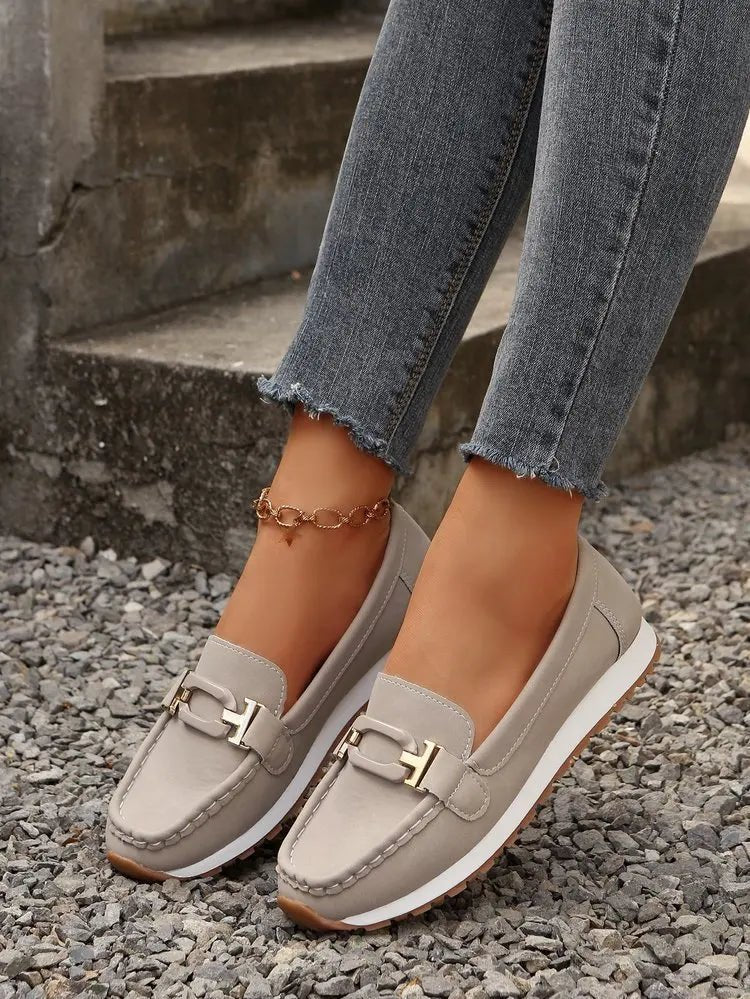 Women's slip-on flat shoes with buckle detail from TrendLux Wear, featuring a sleek and comfortable design for everyday wear.