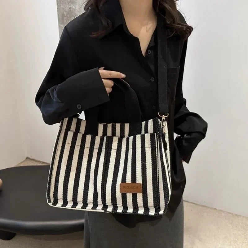 Women's large capacity striped shoulder handbag by TrendLux Wear, showcasing a stylish and spacious hand-held bag with adjustable straps.