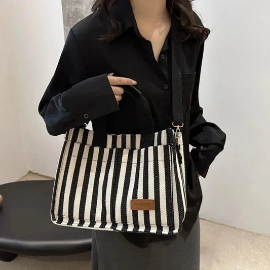 Women's large capacity striped shoulder handbag by TrendLux Wear, showcasing a stylish and spacious hand-held bag with adjustable straps.