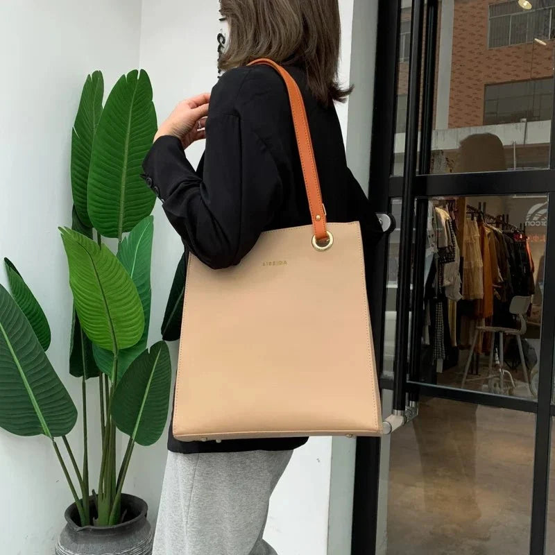 Large women's designer pure leather handbag by TrendLux Wear featuring sleek style and spacious interior, shown in natural light.