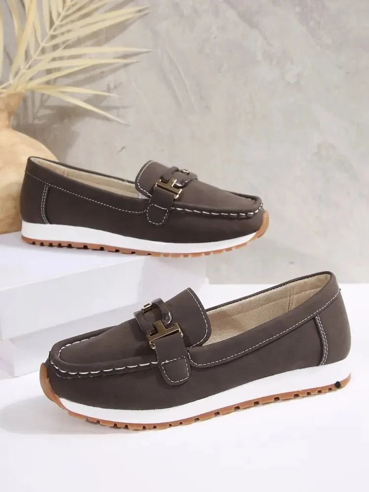 Women's slip-on flat shoes with buckle detail by TrendLux Wear, showcasing a stylish and comfortable footwear design.