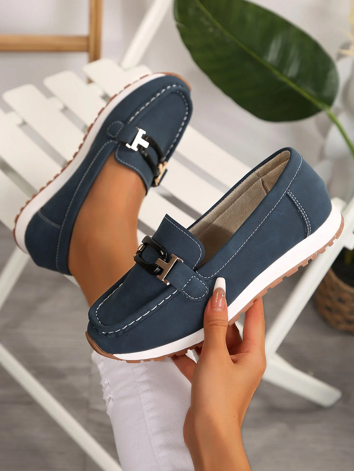 Women's slip-on shoes with buckle detail from TrendLux Wear, featuring a flat design and comfortable fit.