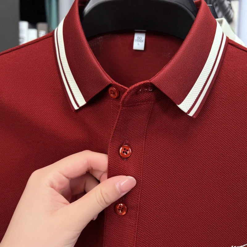 Burgundy short sleeve polo shirt with a classic collar and white striped detailing, featuring embroidered accents.