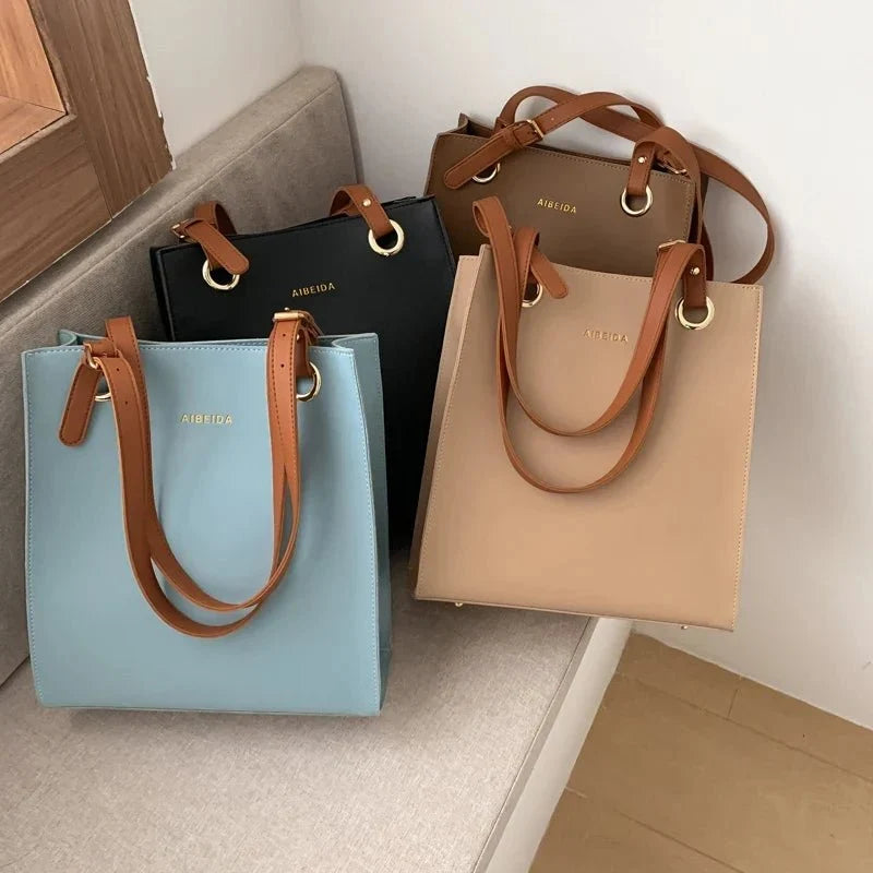 Large women's leather handbag by TrendLux Wear, stylish pure leather design with top handles and sleek finish.