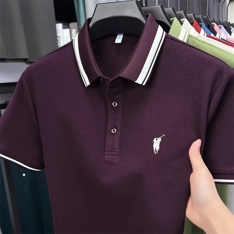 Short sleeve polo shirt in dark purple with white stripes on the collar and a small embroidered pony logo.