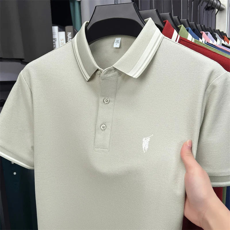 Light green short sleeve polo shirt featuring classic pony embroidery, two-button placket, and contrasting collar details.