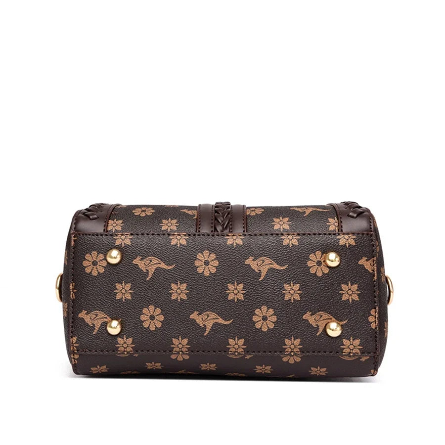 Brown shoulder handbag with a semi-woven style, featuring animal prints and floral patterns; includes gold-tone hardware.