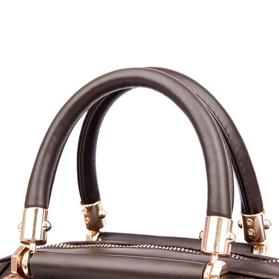 Brown leather shoulder bag with adjustable straps and gold-tone hardware details. Features a structured design for casual use.