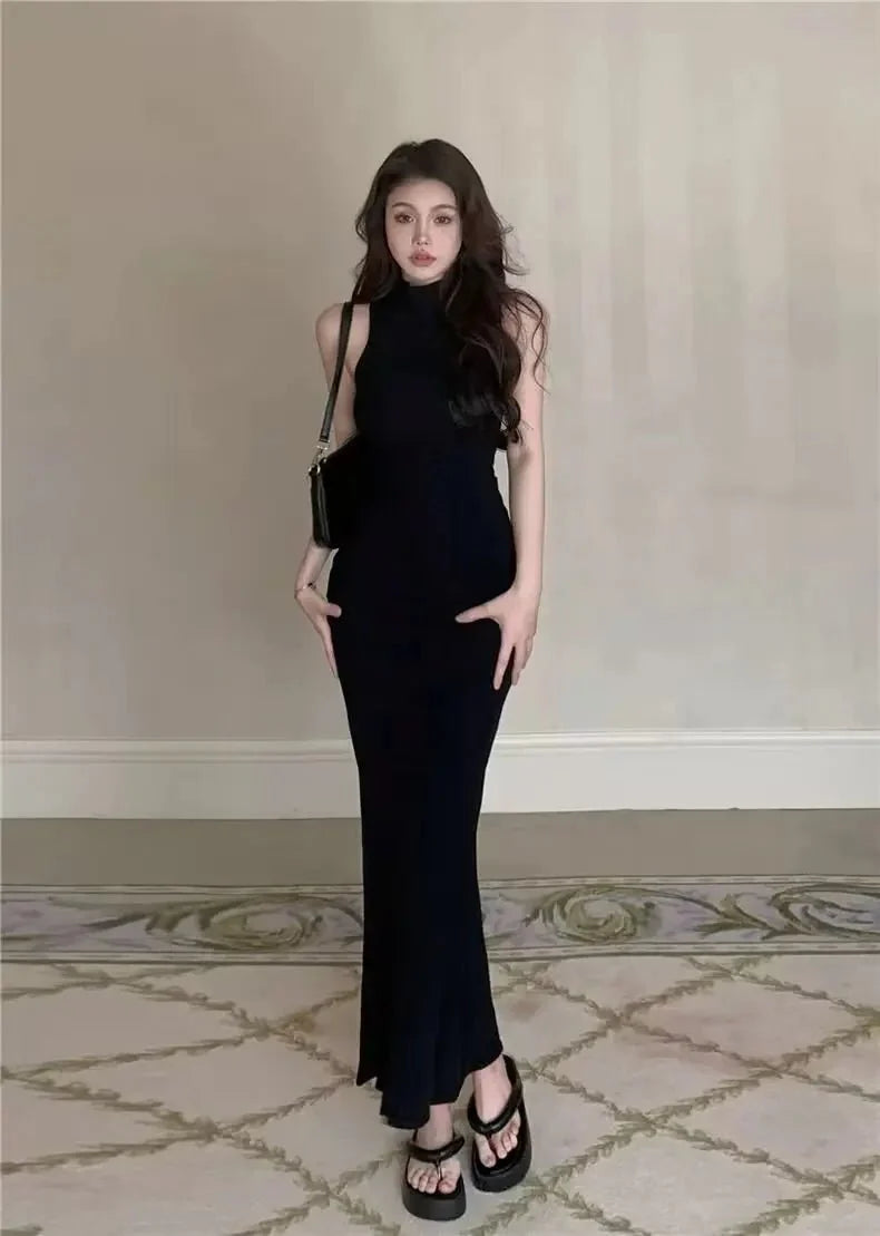 Women's knit turtleneck bodycon ankle-length maxi dress by The Glow Sanctuary, shown in a close-up of the fitted, ribbed fabric.