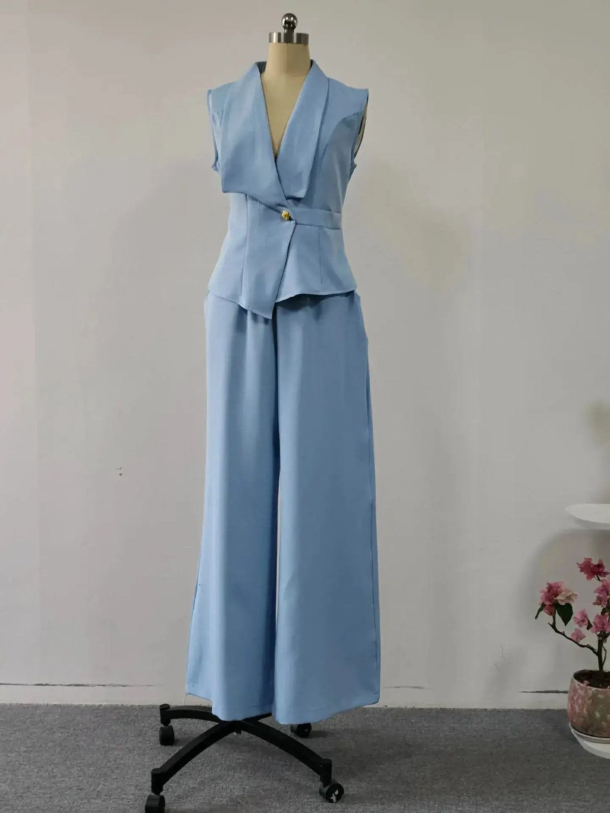 Women's spring sleeveless 2-piece suit by TrendLux Wear, featuring a stylish top and matching pants in a light, breezy fabric.
