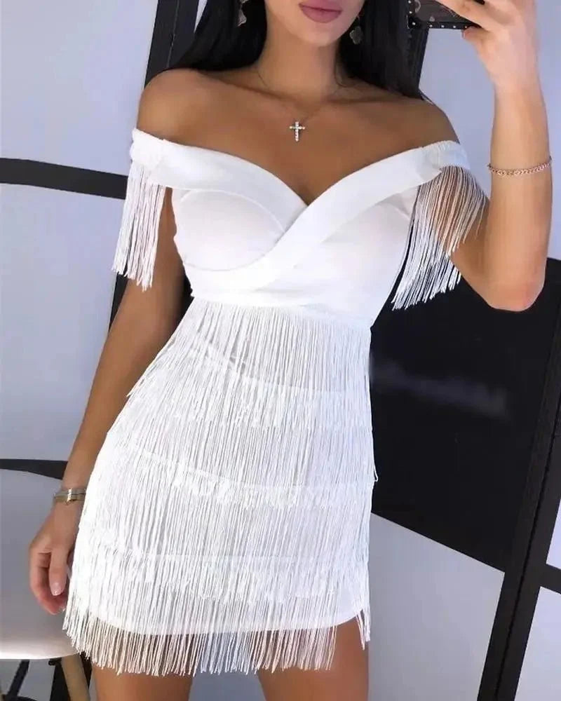 Black fringed one-shoulder mini dress by The Glow Sanctuary, featuring stylish fringe details and a sleek, fitted silhouette.