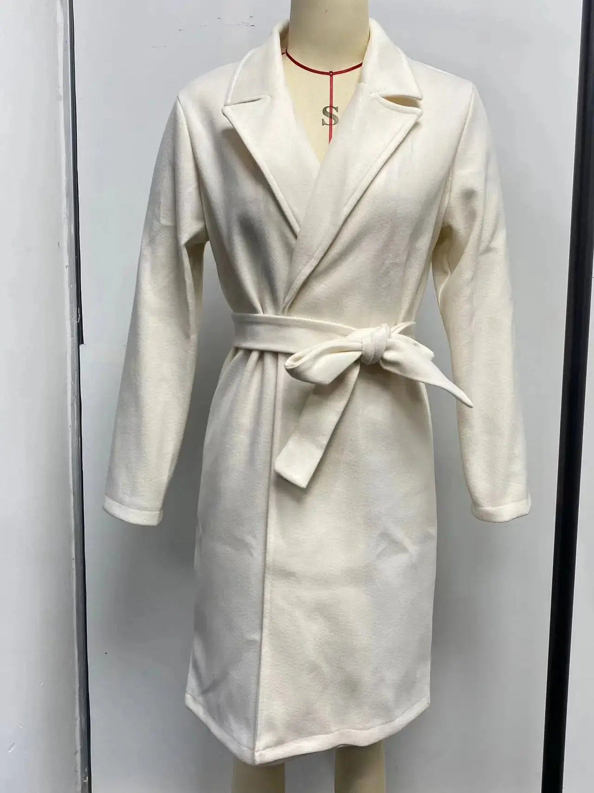 Women's solid woolen lapel coat by TrendLux Wear, showing the classic design and tailored fit in warm wool fabric.