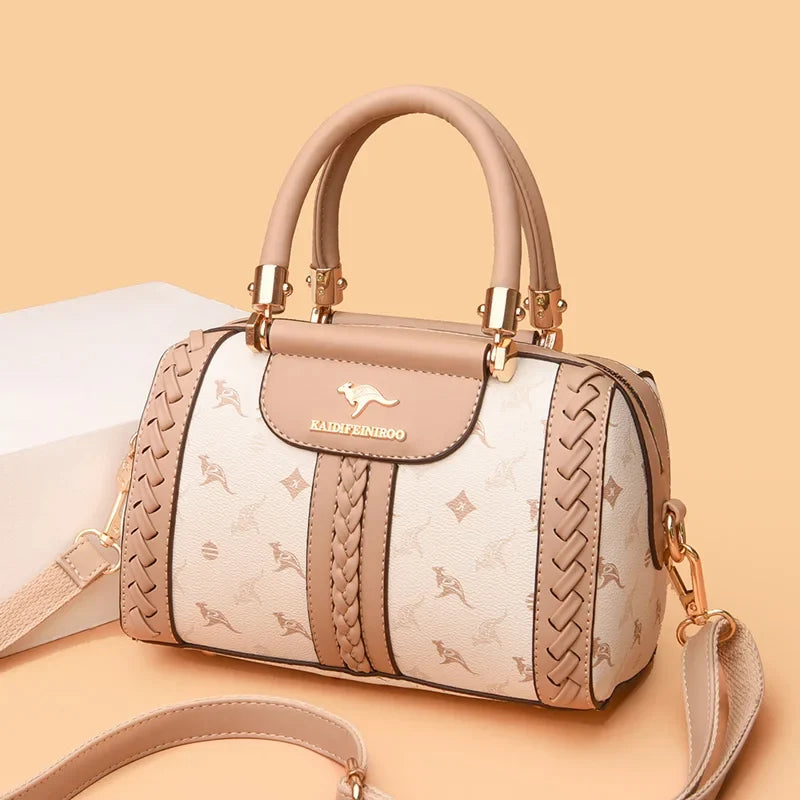 Designer shoulder handbag in soft beige leather with woven accents and gold-tone hardware, featuring an adjustable strap.