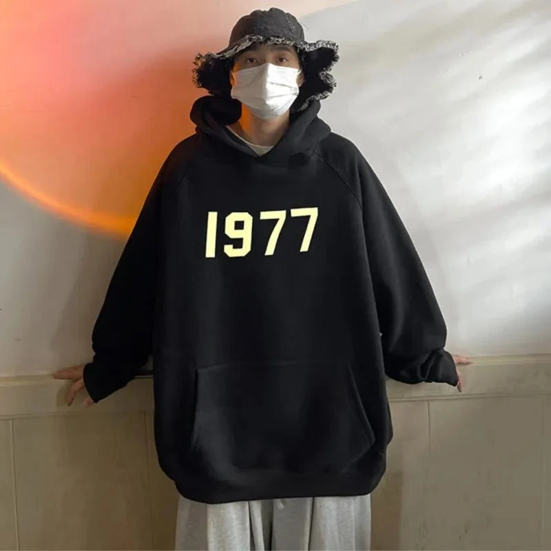 Men's TrendLux Wear 1977 printed Harajuku hoodie with loose fit long sleeves, featuring bold graphic design and comfortable fabric.