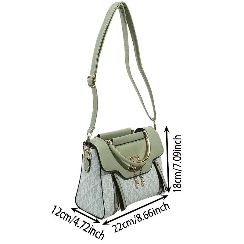 Green embossed handbag with a gold handle and a shoulder strap, featuring a solid rectangular shape.