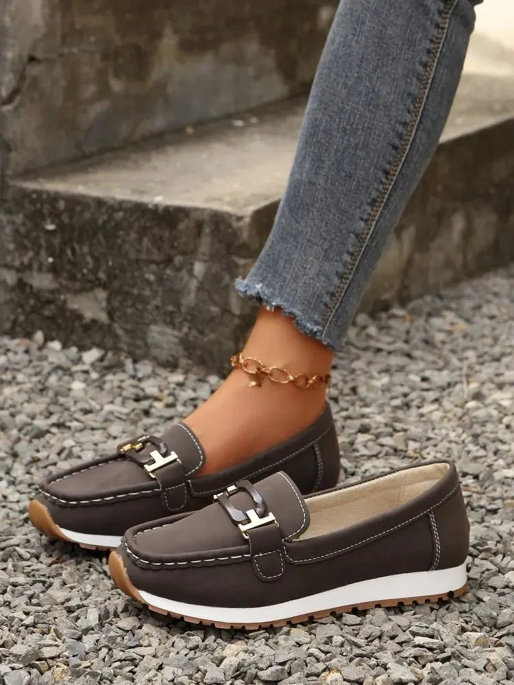 Women's slip-on flat shoes with buckle detail from TrendLux Wear, featuring a sleek design and comfortable fit.