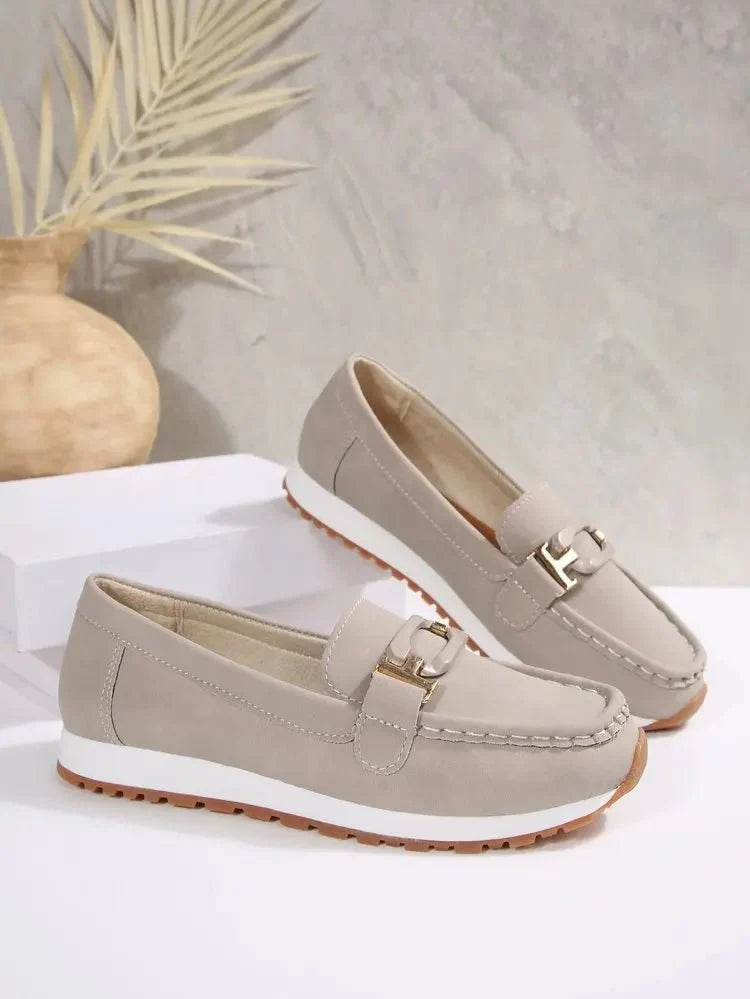 Women's slip-on flat shoes with buckle detail by TrendLux Wear, featuring a sleek and comfortable design for everyday wear.