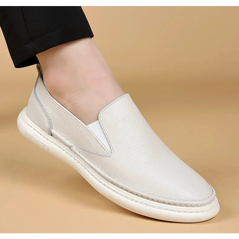 Men's genuine leather casual loafers by TrendLux Wear, breathable slip-on flat shoes in solid color with a sleek design.
