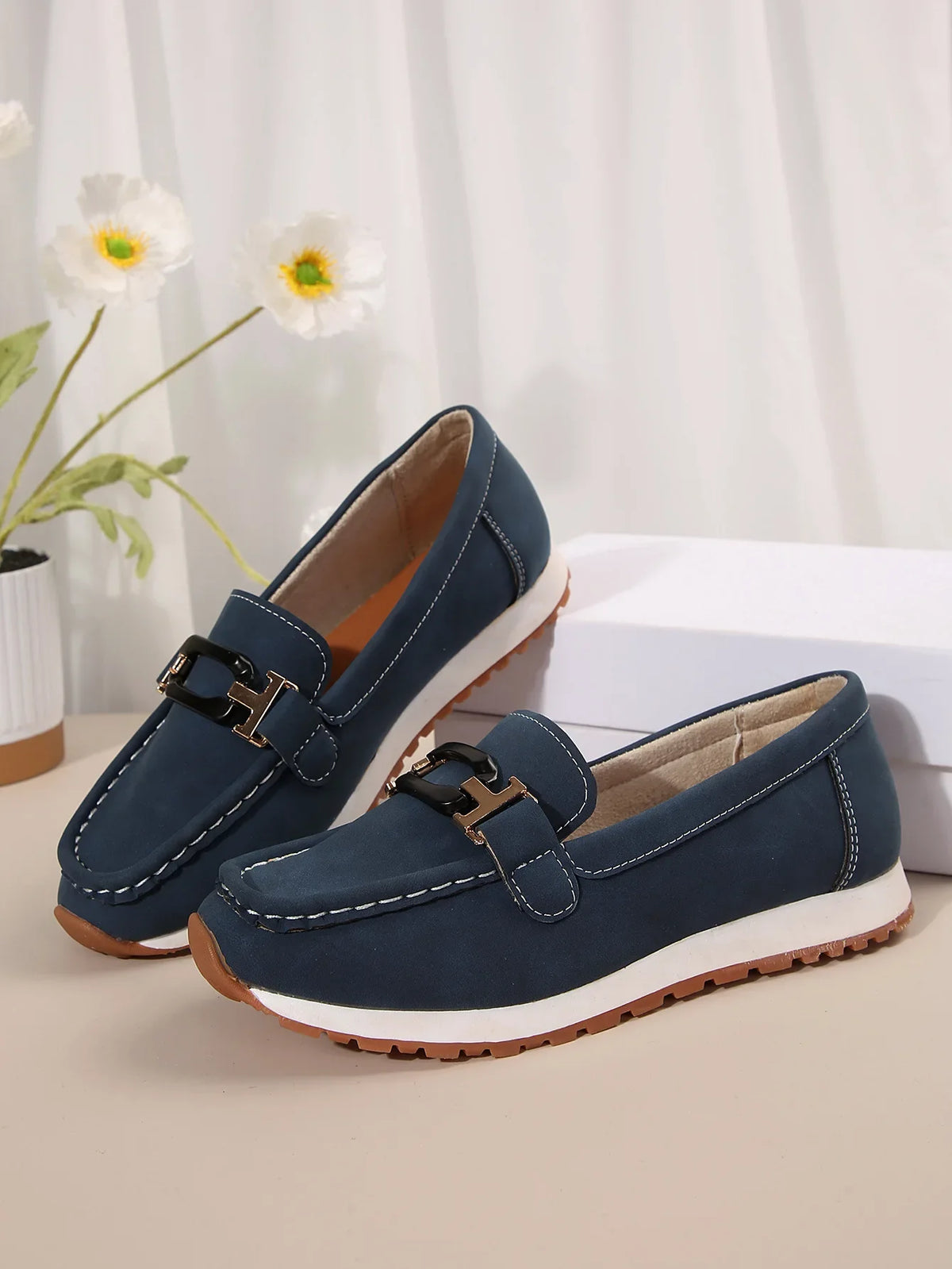 Women's slip-on flat shoes with buckle detail by TrendLux Wear, featuring a sleek design and comfortable fit.