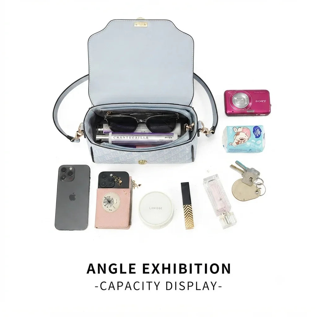 Versatile light blue rectangular handbag with a shoulder strap, displayed open with inside contents like sunglasses and cosmetics.