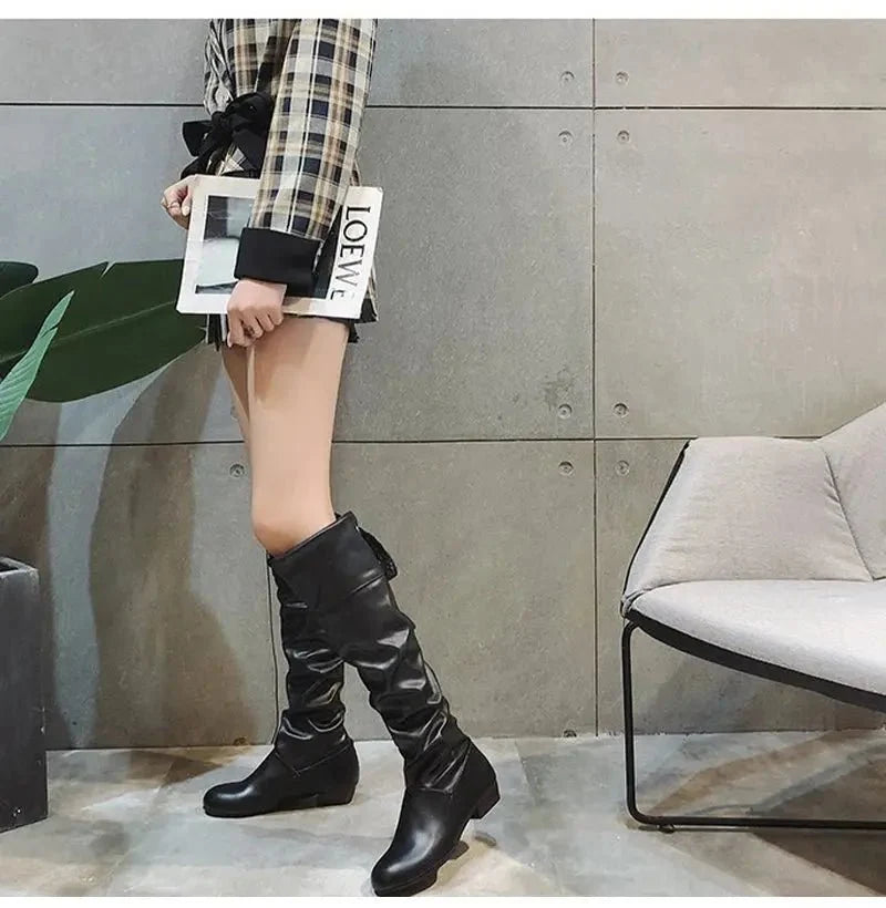 Women's knee-high boots with pleated design and lace-up closure from TrendLux Wear, stylish footwear for fashion-forward looks.